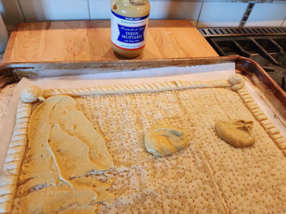 spreading mustard on pastry